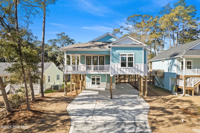 view of front of home with french doors, a carport, and central AC unit