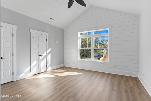 interior space featuring ceiling fan, vaulted ceiling, and light hardwood / wood-style floors