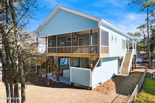 view of front of house with ceiling fan and a sunroom