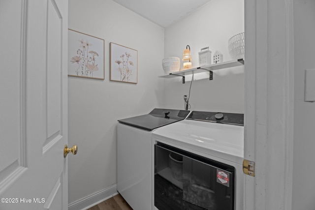 laundry room with wood-type flooring and separate washer and dryer