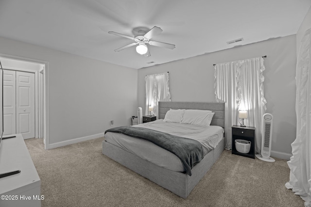 carpeted bedroom with a closet and ceiling fan