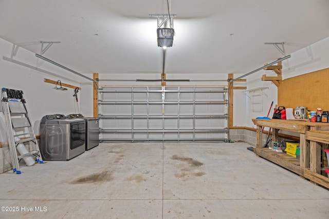 garage with a garage door opener and washer and dryer