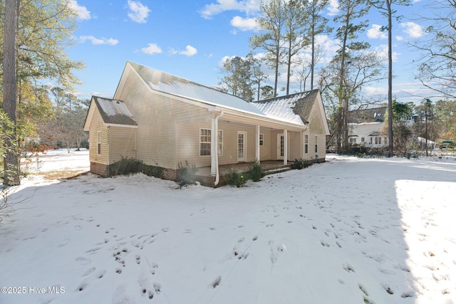 view of snow covered exterior with covered porch