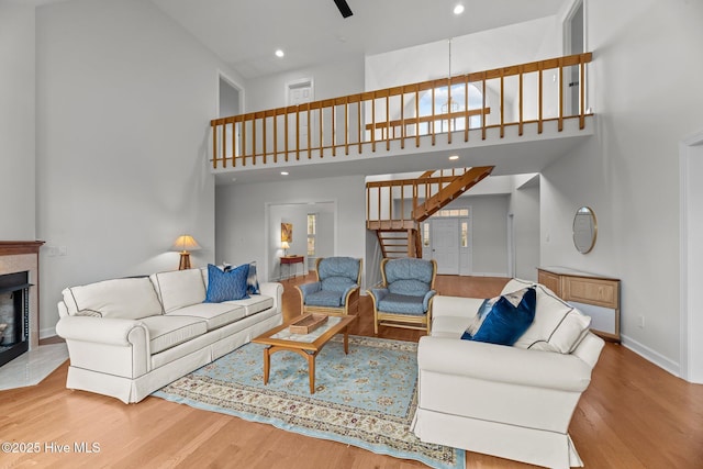 living room with a towering ceiling and wood-type flooring