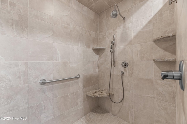 bathroom with tiled shower