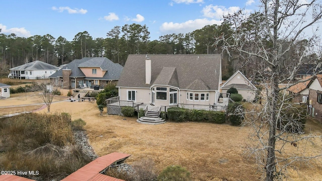 back of property with a wooden deck