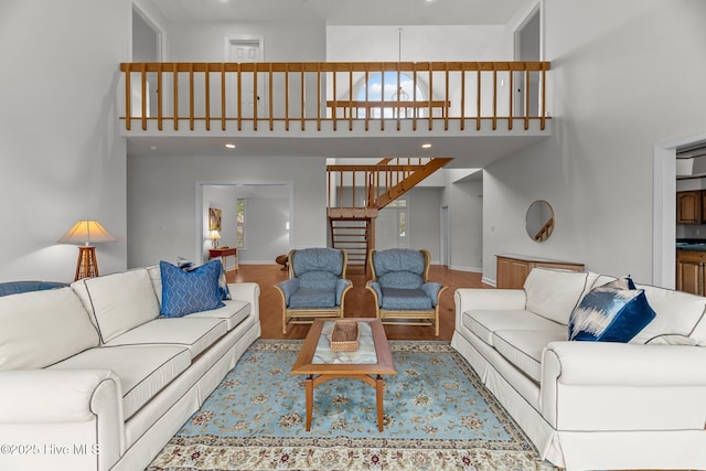 living room with a high ceiling and hardwood / wood-style floors