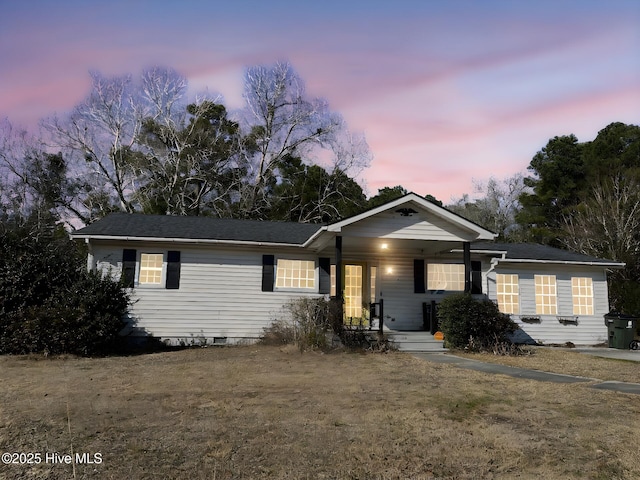 ranch-style home with a yard