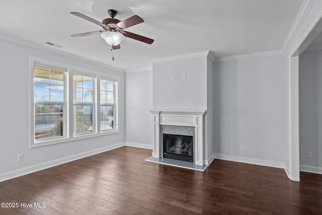 unfurnished living room with a high end fireplace, dark hardwood / wood-style flooring, ceiling fan, and crown molding