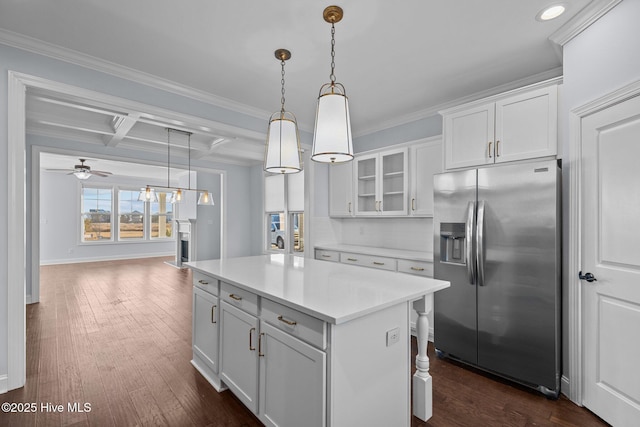 kitchen featuring ceiling fan, coffered ceiling, stainless steel fridge with ice dispenser, beamed ceiling, and white cabinets