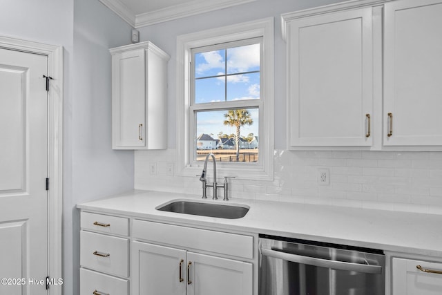 kitchen with sink, tasteful backsplash, stainless steel dishwasher, white cabinets, and ornamental molding