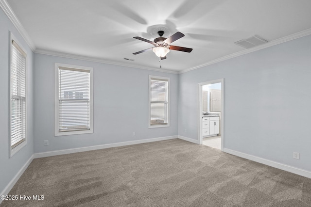 unfurnished room with ceiling fan, light colored carpet, and ornamental molding