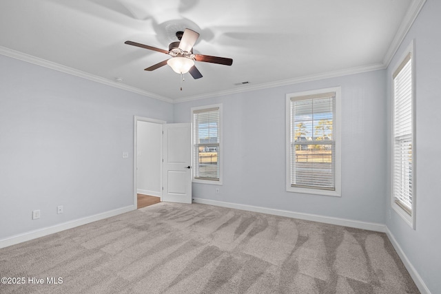 empty room featuring light carpet, ceiling fan, and ornamental molding