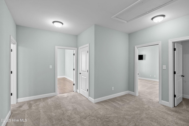 unfurnished room featuring light colored carpet