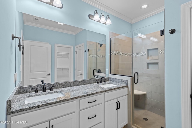 bathroom with vanity, crown molding, and walk in shower