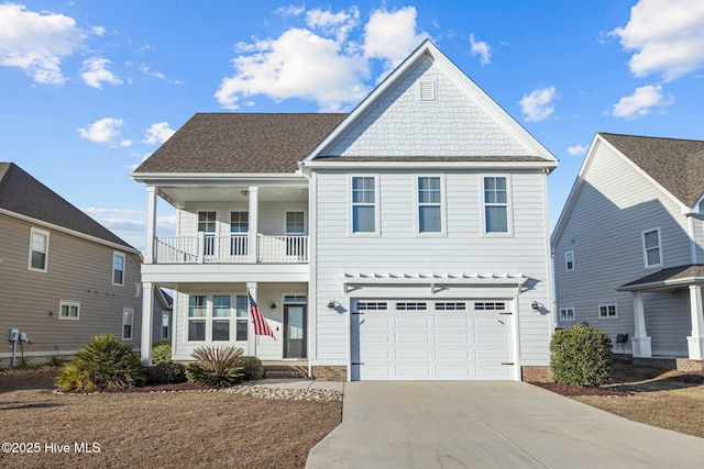 view of front of home with driveway, a balcony, and an attached garage