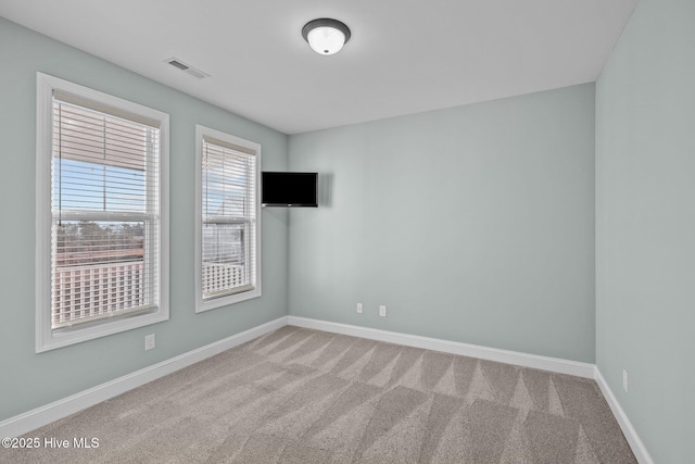 unfurnished room featuring carpet