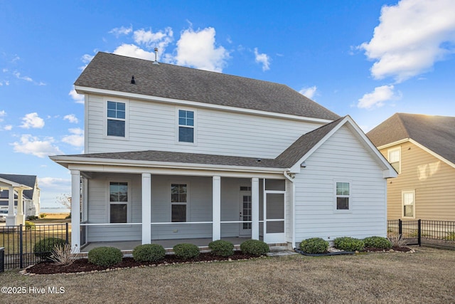 view of front of house featuring a sunroom, a porch, and a front yard