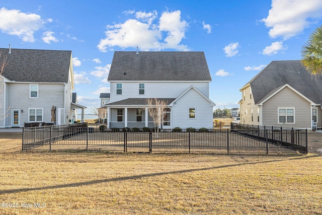 back of property with a lawn