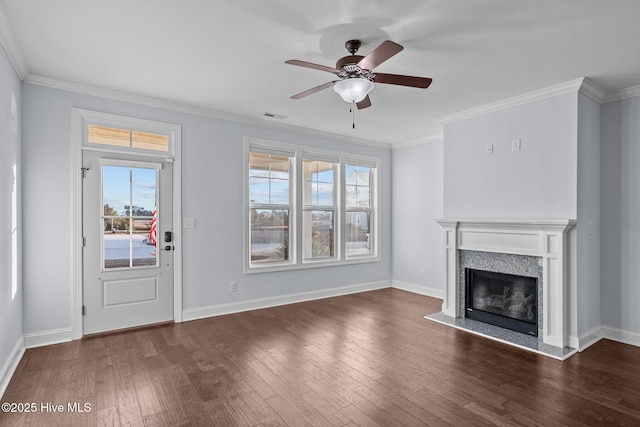 unfurnished living room featuring a premium fireplace, crown molding, ceiling fan, and dark hardwood / wood-style floors