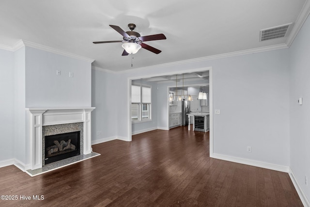 unfurnished living room featuring ceiling fan, crown molding, and a premium fireplace