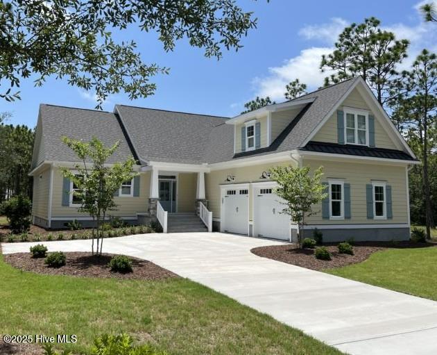 view of front of home with a garage and a front lawn