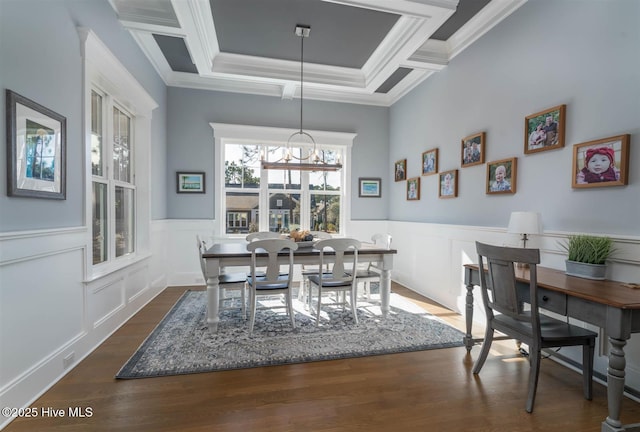 dining room with a notable chandelier, crown molding, and dark wood-type flooring