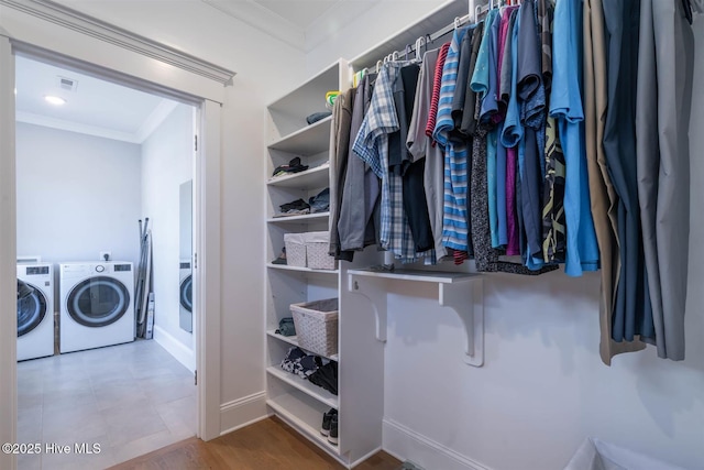 walk in closet featuring washing machine and clothes dryer