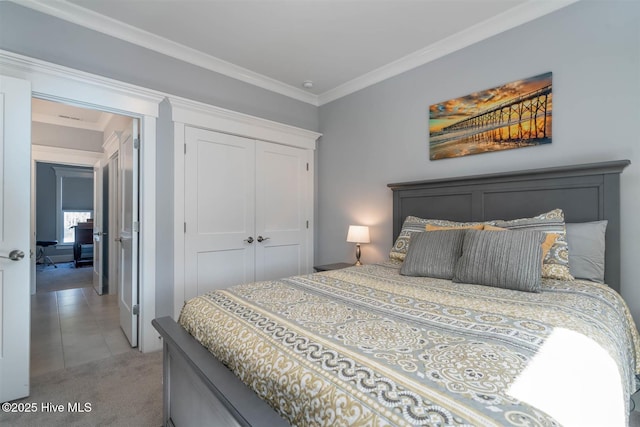 bedroom featuring crown molding, light colored carpet, and a closet