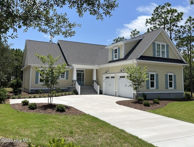 view of front of house with a garage and a front yard