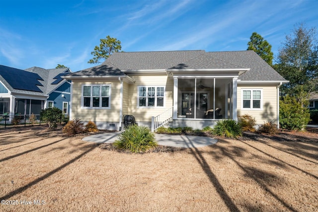 back of house with a yard, a sunroom, and a patio