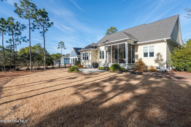 back of house featuring a patio area and a sunroom