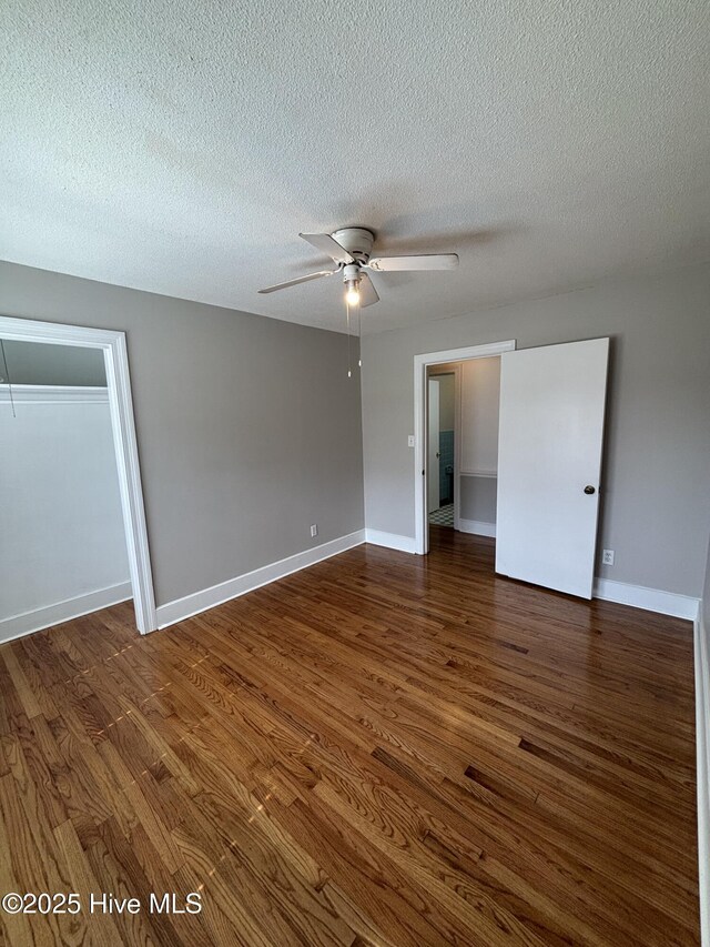 carpeted bedroom featuring a textured ceiling, ceiling fan, a closet, and connected bathroom