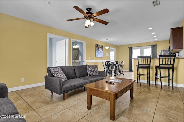 tiled living room featuring ceiling fan