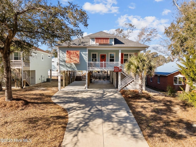 view of front of home with central AC, a porch, and a carport