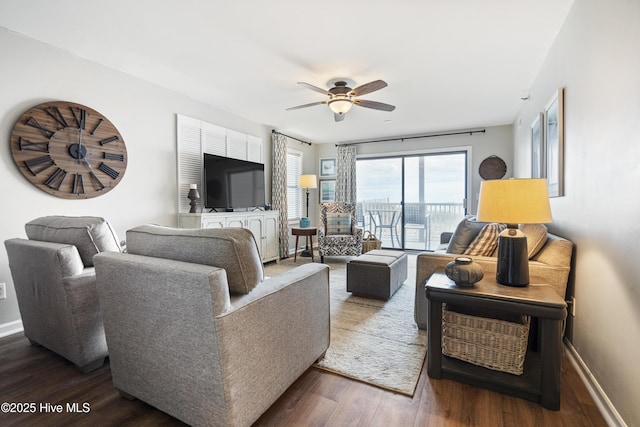 living room with dark hardwood / wood-style floors and ceiling fan