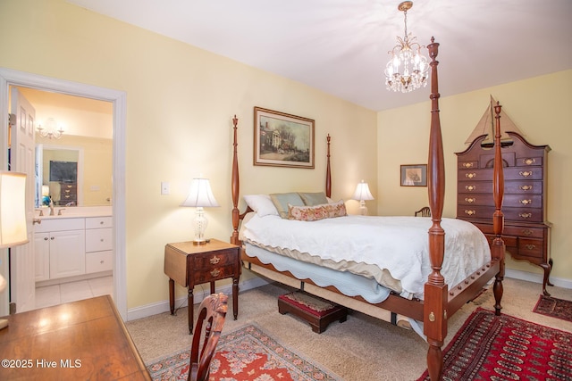 bedroom with light colored carpet, sink, connected bathroom, and a notable chandelier