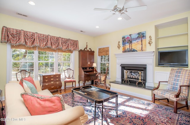 living room featuring ceiling fan and wood-type flooring