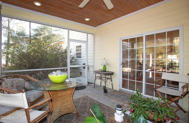 sunroom with ceiling fan and wood ceiling