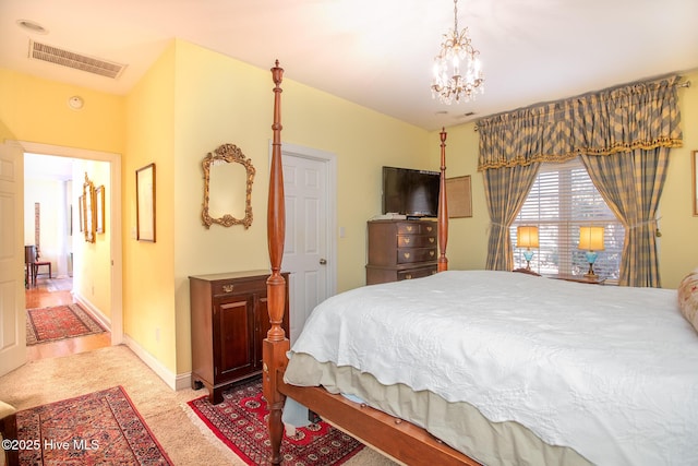 carpeted bedroom with a chandelier