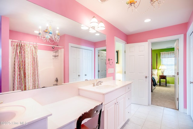 bathroom featuring an inviting chandelier, tile patterned floors, vanity, and shower / tub combo with curtain