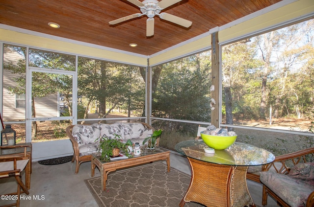 sunroom with ceiling fan and wooden ceiling