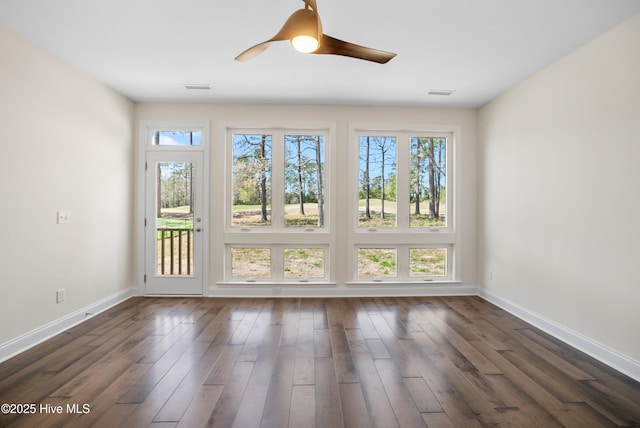 spare room featuring dark hardwood / wood-style flooring and ceiling fan