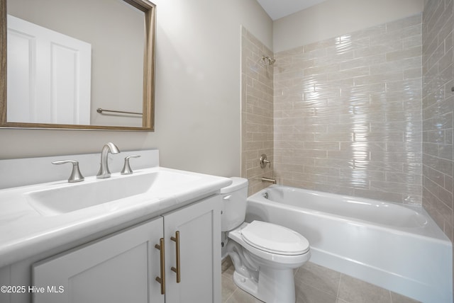 full bathroom with tile patterned flooring, vanity, toilet, and tiled shower / bath