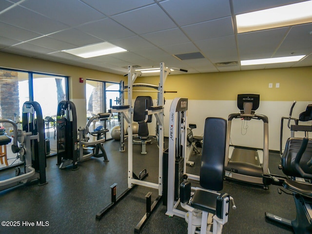 exercise room featuring a drop ceiling