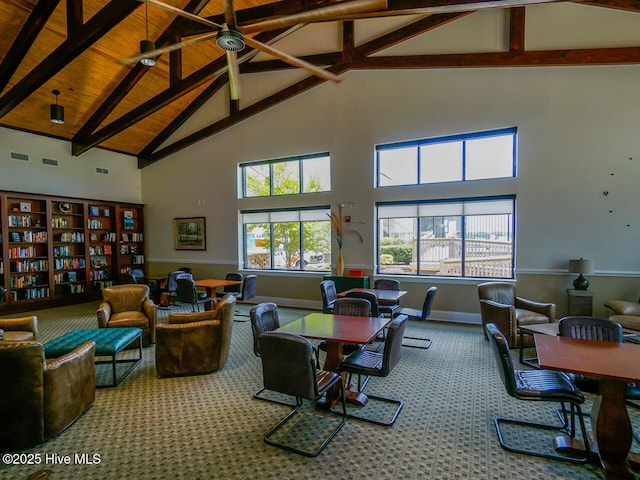 carpeted living room with ceiling fan, beam ceiling, and high vaulted ceiling