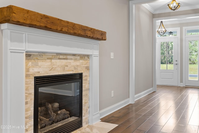 details with a fireplace, wood-type flooring, and crown molding