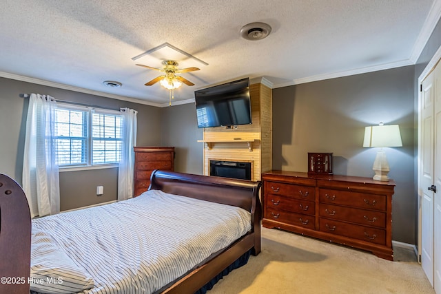 bedroom with a fireplace, crown molding, light carpet, and a textured ceiling