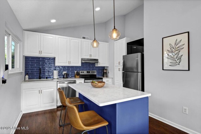 kitchen featuring sink, backsplash, white cabinets, and appliances with stainless steel finishes