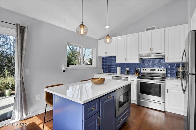 kitchen featuring pendant lighting, appliances with stainless steel finishes, blue cabinets, and white cabinets